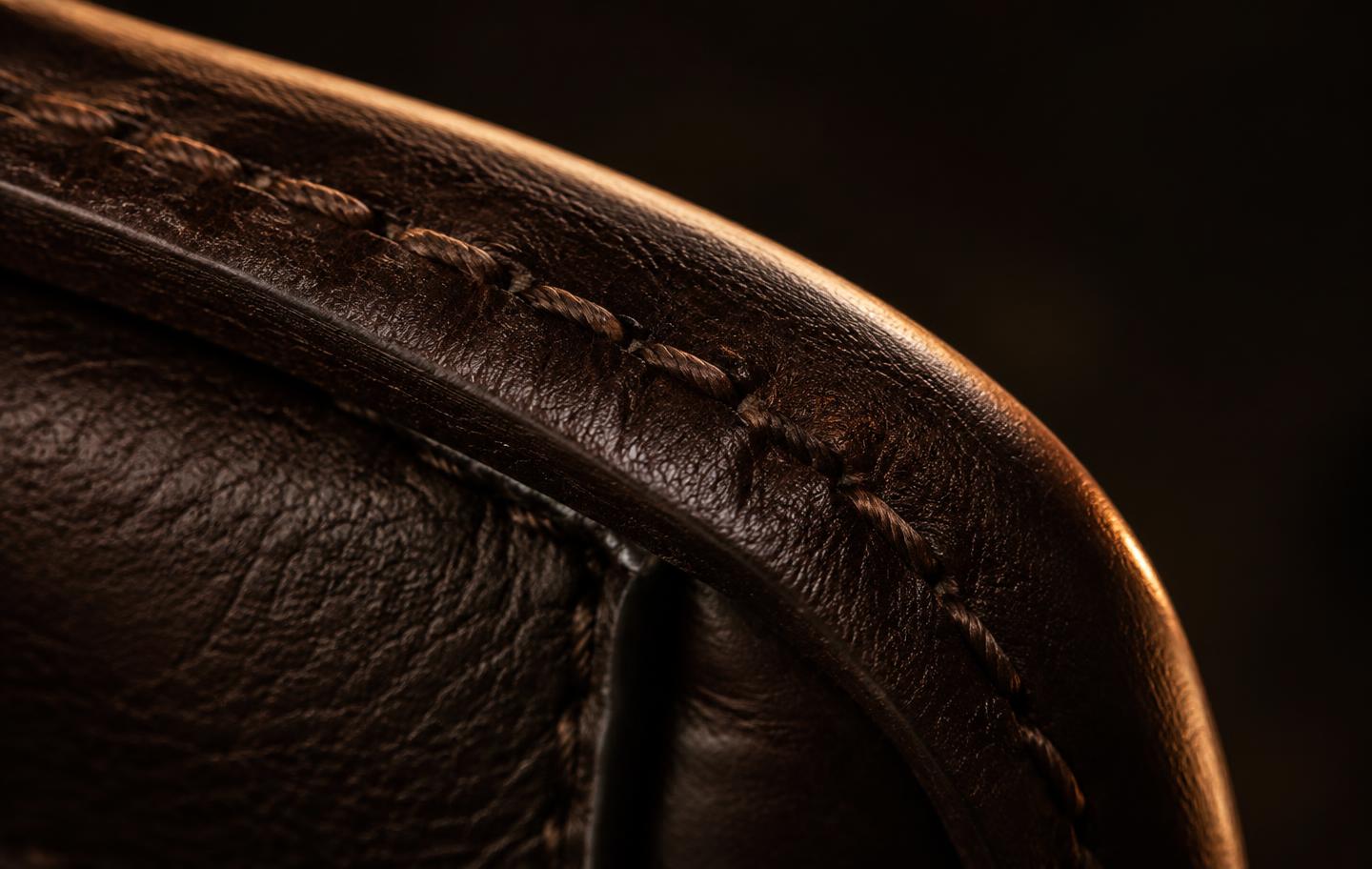 Macro detail of leather stitching and grain